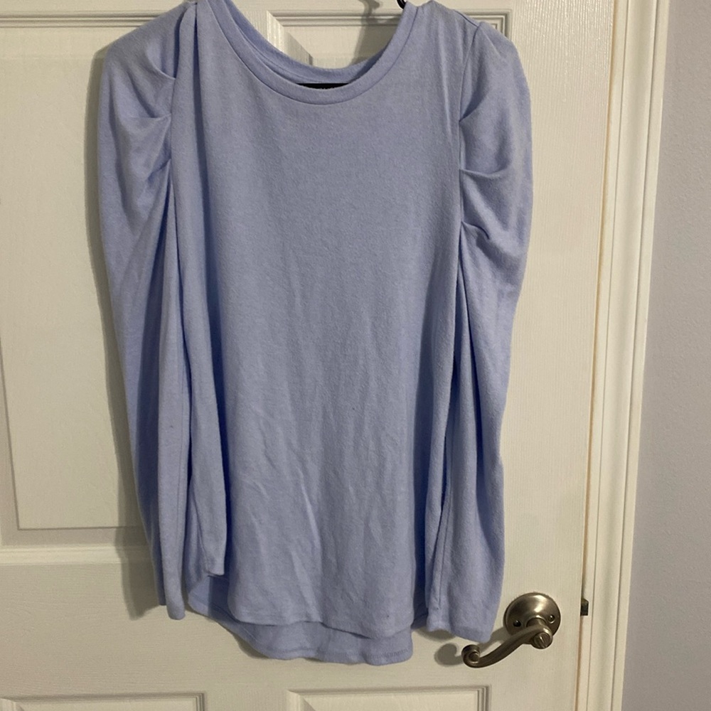 Small sweater but runs baggy. Can fit a medium sized person
